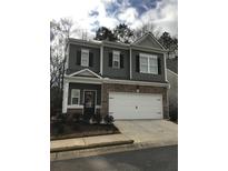 Charming two-story home features a brick facade, two-car garage and well-maintained landscaping at 230 Hickory Commons Way, Canton, GA 30115
