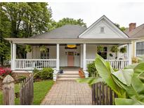 Charming craftsman-style home with inviting front porch, manicured lawn, and pink front door at 290 Georgia Se Ave, Atlanta, GA 30312