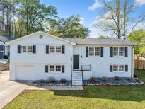 Charming painted brick split-level home with a manicured lawn, offering classic curb appeal at 294 Arnold Mill Rd, Woodstock, GA 30188