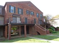 Charming brick townhouse with a balcony and well-maintained landscaping at 3091 Colonial Way # B4, Atlanta, GA 30341