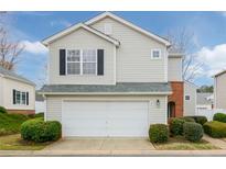 Charming two-story home with a white garage door and well-manicured landscaping at 102 Manley Ct, Woodstock, GA 30188