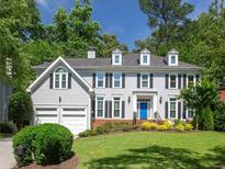Charming two-story home with a manicured lawn, classic architectural design, and a welcoming three-car garage at 710 Greystone Ne Park, Atlanta, GA 30306
