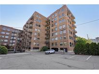 Brick building featuring arched windows, balconies, parking and street-level entry at 3235 Roswell Ne Rd # 801, Atlanta, GA 30305