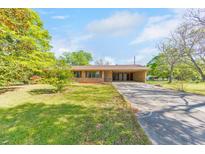 Charming single-story home featuring a spacious front yard and convenient covered parking at 1955 Starr Sw Rd, Conyers, GA 30094