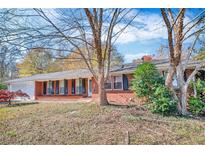 Charming single-story brick home featuring a well-maintained front yard and attached garage at 831 Sinyard Rd, Lithia Springs, GA 30122