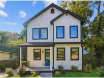 Charming two-story home featuring a modern farmhouse design, eye-catching blue door and a welcoming front porch at 1045 Mcdaniel St, Atlanta, GA 30310