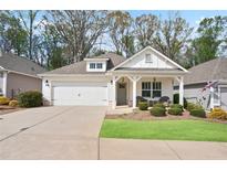 Charming single-story home with a well-manicured lawn and inviting front porch seating area at 161 Grace Cir, Acworth, GA 30102