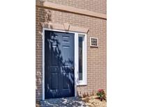 Stylish navy blue front door framed with brick and white trim, adding curb appeal to the home at 4095 Stillwater Dr, Duluth, GA 30096