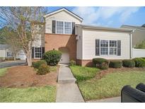 Charming two-story townhome with landscaped front yard and neutral siding at 612 Windcroft Nw Cir, Acworth, GA 30101