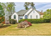 Charming home featuring a well-manicured lawn and lush landscaping at 717 Robinson Farms Dr, Marietta, GA 30068