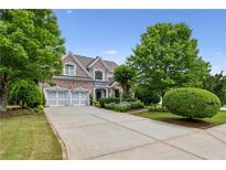 Beautiful brick home with a well-manicured lawn, a two-car garage, and charming curb appeal at 1239 Bonshaw Trl, Marietta, GA 30064