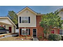 Charming two-story townhouse with a brick facade, vinyl siding, black shutters, and a well-manicured lawn at 4480 Maple Valley Dr, Cumming, GA 30040