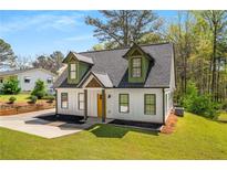 Charming home featuring eye-catching dormers, a new roof, and a bright yellow front door at 1071 N Price Rd, Sugar Hill, GA 30518