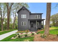 Charming two-story home featuring a covered porch and meticulously landscaped front yard at 2869 4Th Sw St, Atlanta, GA 30315