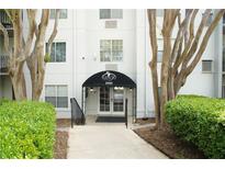 Welcoming condo building entrance with professional landscaping and covered entry at 970 Sidney Marcus Ne Blvd # 2203, Atlanta, GA 30324