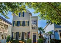 Charming two-story home with symmetrical design, blue shutters, covered porch, and well-manicured landscaping at 4124 Hunt St, Covington, GA 30014