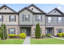 Charming townhome featuring a beautifully landscaped front yard and welcoming entryway at 4133 Shoals Ln, Union City, GA 30291