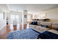 Bright and spacious living room featuring hardwood floors and an open floor plan with kitchen and dining area at 195 14Th Ne St # Ph206, Atlanta, GA 30309