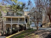 Charming two-story home with a large front porch and a two-car garage nestled among trees at 314 Sable Trace Pass, Acworth, GA 30102