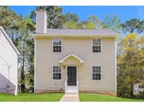 Charming two-story home with a cozy front porch and well-maintained lawn at 5228 Kirk Dr, Atlanta, GA 30349