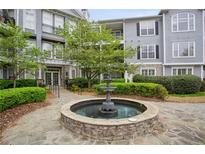 Elegant condo community with a central water fountain and manicured landscaping at 4100 Paces Se Walk # 2309, Atlanta, GA 30339