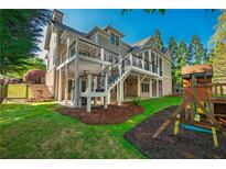 Expansive backyard featuring a two-story deck and a charming playset at 6186 Talmadge Nw Run, Acworth, GA 30101
