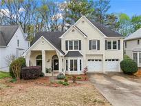 Charming two-story home with a well-manicured lawn, a two-car garage, and a classic brick facade at 4829 Thicket Nw Path, Acworth, GA 30102