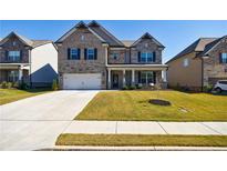 Beautiful two-story home with brick and stone exterior, well-manicured lawn, and attached two-car garage at 3788 Franks Way, Loganville, GA 30052