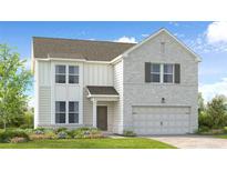 Charming two-story home featuring light brick, inviting entry, and a two-car garage at 1773 Fawlocke Run, Loganville, GA 30052