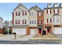 Charming townhome featuring brick accents, neutral siding, and a convenient attached two-car garage at 5987 Turfway Park Ct, Sugar Hill, GA 30518