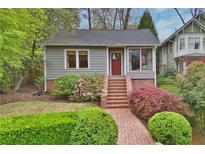 Charming home featuring a landscaped front yard and brick pathway leading to the front door at 215 Terrace Ne Dr, Atlanta, GA 30305