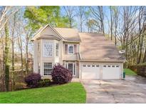 Charming home with a two-car garage, bay window, manicured lawn, and mature trees at 3684 Wittenburg Ct, Decatur, GA 30034