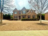 Charming two-story brick home with manicured landscaping and a welcoming front porch at 1250 Edgebrook Ln, Snellville, GA 30078