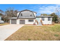 Charming two-story home featuring a brick facade, two-car garage, and a welcoming blue front door at 3862 Northstrand Dr, Decatur, GA 30035