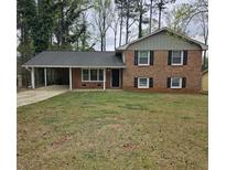 Charming two-story brick home with a covered carport and a well-manicured lawn at 1968 Copperfield Cir, Decatur, GA 30035