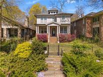 Charming two-story home with a landscaped front yard and inviting front porch at 1054 Euclid Ne Ave, Atlanta, GA 30307
