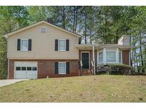 Charming two-story home with a combination brick and siding exterior and a well-maintained front yard at 1512 Daniel Ln, Lawrenceville, GA 30046