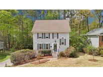 Charming two-story home with a well-manicured front yard and inviting entrance surrounded by mature trees at 4783 Deer Chase, Powder Springs, GA 30127