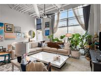 Bright living room featuring a large window, modern decor, stylish seating, and an open, airy atmosphere at 5200 Peachtree Rd # 2116, Atlanta, GA 30341