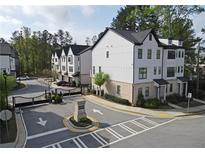 Beautiful exterior view of new townhomes with manicured landscaping and a community gate at 1494 Addison Pl, Decatur, GA 30033