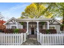 Charming home featuring a welcoming front porch, white picket fence, and manicured landscaping at 73 Waddell Ne St, Atlanta, GA 30307