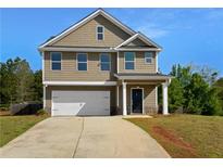 Charming two-story home featuring neutral siding, a two-car garage, and a well-manicured front yard at 280 Mcgiboney Ln, Covington, GA 30016
