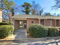 Charming brick townhouse with covered entryway and well-maintained landscaping at 3301 Henderson Mill Rd # 1, Atlanta, GA 30341