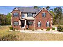 Charming brick two-story home with well-manicured front yard and classic architectural details at 132 Windmeadow Way, Fayetteville, GA 30214