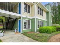 Multi-level exterior view of home with a colorful exterior paint scheme, stairs, and well-kept landscaping at 1255 Branch Dr, Tucker, GA 30084