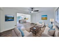 Bright living room featuring hardwood floors, an open dining area, and comfortable contemporary furnishings at 570 Harris Sw Ct, Marietta, GA 30060