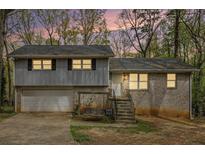 Charming split-level home with brick and siding, garage, and inviting front steps at 626 Mincey Ct, Stone Mountain, GA 30087
