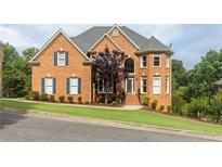 Brick home boasts meticulous landscaping, a charming turret, and stately curb appeal at 4020 Balleycastle Ln, Duluth, GA 30097