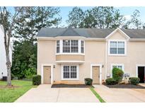 Inviting exterior elevation of a two-story home with a manicured front yard and a large front window at 3116 Fields Dr, Lithonia, GA 30038