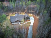 Stunning aerial view of home with long driveway, wooded acreage, and immaculate landscaping at 313 Morgan Rd, Temple, GA 30179